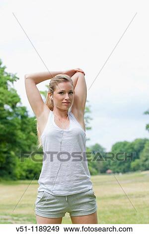 Blonde woman stretching in the park View Large Photo Image Stock Photo - Blonde woman stretching in the park. Fotosearch