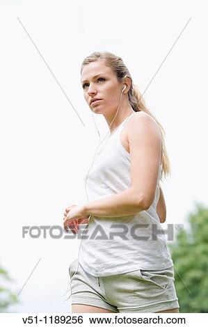 Blonde woman stretching in the park View Large Photo Image Stock Photograph - Blonde woman stretching in the park. Fotosearch