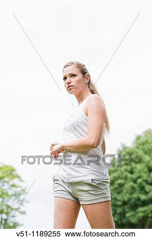Blonde woman stretching in the park View Large Photo Image Stock Photography - Blonde woman stretching in the park. Fotosearch