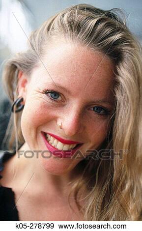 Stock Photo - Blonde woman wearing a nose ring. Fotosearch