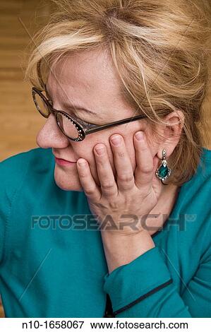 Stock Photo - Blonde woman wearing glasses. Fotosearch