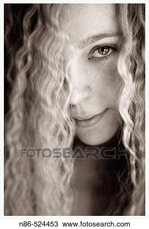 Stock Image - Blonde woman with curly hair. Fotosearch