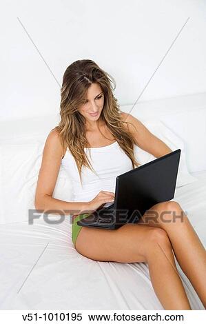 Blonde woman with laptop in bed View Large Photo Image Stock Photography - Blonde woman with laptop in bed. Fotosearch