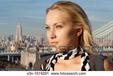 Stock Image - Blonde woman with New York City in Background. Fotosearch