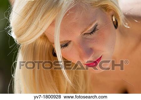 Blonde young girl looking down View Large Photo Image Stock Photo - Blonde young girl looking down. Fotosearch