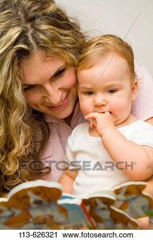 Blonde young mother with her baby girl looking at picture book View Large Photo Image Stock Image - Blonde young mother with her baby girl looking at picture book. Fotosearch