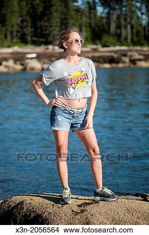 Picture - Blonde young woman on beach in Maine.. Fotosearch