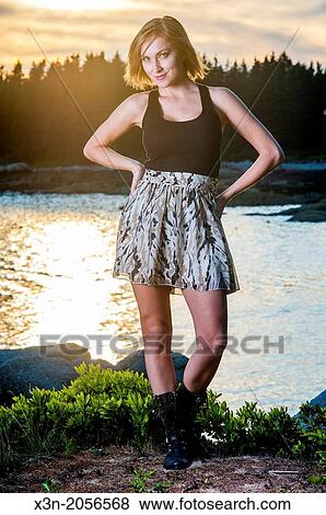 Stock Photo - Blonde young woman on beach in Maine.. Fotosearch