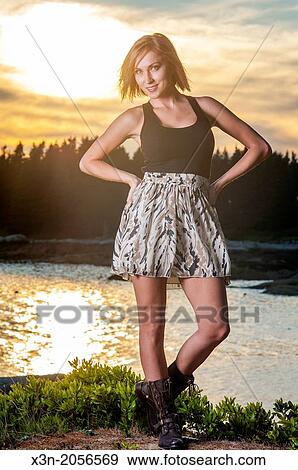 Stock Photo - Blonde young woman on beach in Maine.. Fotosearch