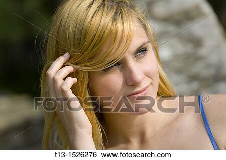 Blonde young woman portrait, adjusting hair View Large Photo Image Stock Photograph - Blonde young woman portrait, adjusting hair. Fotosearch