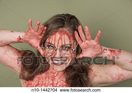 Picture - Bloody young woman wearing glasses. Fotosearch