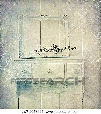 Stock Image - Blossom and old picture frame on wooden shelf, textured image.. Fotosearch