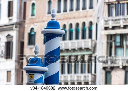Stock Image - Blue and white striped bollards, Venice, Italy, Europe. Fotosearch