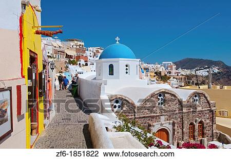 Stock Image - Blue domb church of beautiful Oia in Greek Island of Santorini Greece on cliffs on holiday. Fotosearch