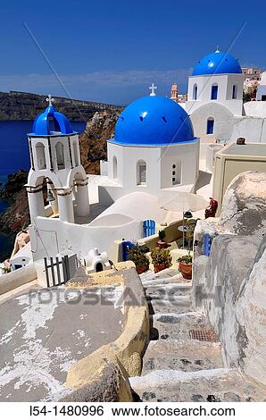 Stock Photograph - Blue dome whitewash buildings Oia Santorini Greece Island Mediterranean Cruise Aegean. Fotosearch