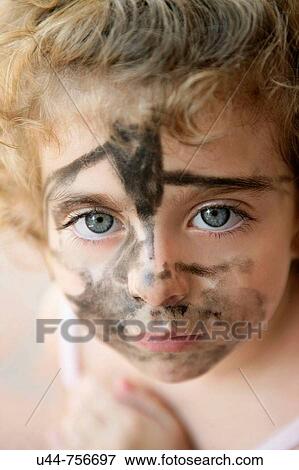 Stock Photo - Blue eyes toddler with painted in black face. Fotosearch