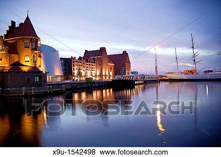 blue hour at the harbor with the building of the Maritime pilots, Ozeaneum and the three-mast barque Gorch Fock 1 in the Hanseatic City of Stralsund, Mecklenburg-Vorpommern, Germany View Large Photo Image Stock Photo - blue hour at the harbor with the building of the Maritime pilots, Ozeaneum and the three-mast barque Gorch Fock 1 in the Hanseatic City of Stralsund, Mecklenburg-Vorpommern, Germany. Fotosearch