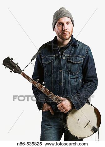 Stock Photography - Blue jean jacketed man with banjo. Fotosearch
