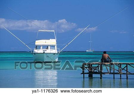 Blue lagoon and big game fishing boat, Bain Beauf beach, Cape Malheureux, Mauritius Island, Indian Ocean View Large Photo Image Stock Photograph - Blue lagoon and big game fishing boat, Bain Beauf beach, Cape Malheureux, Mauritius Island, Indian Ocean. Fotosearch