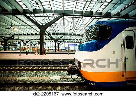 Stock Photo - blue white orange, Sprinter train stopped at Rottedam Centraal.. Fotosearch