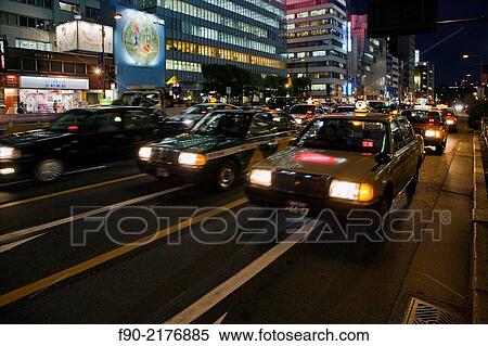 Blur of taxis at dusk in Omotesando, Tokyo, Japan. View Large Photo Image Stock Photography - Blur of taxis at dusk in Omotesando, Tokyo, Japan.. Fotosearch