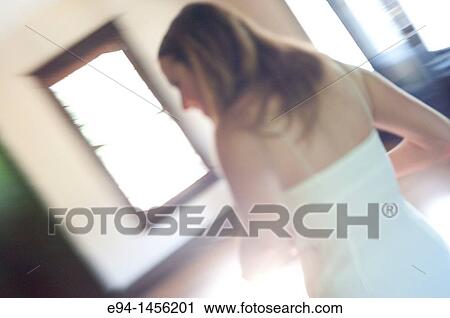 Blurry back view of a woman in a white dress inside of a home View Large Photo Image Stock Image - Blurry back view of a woman in a white dress inside of a home. Fotosearch
