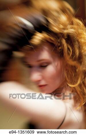 Stock Photo - Blurry profile portrait of a 28 year old redheaded woman. Fotosearch