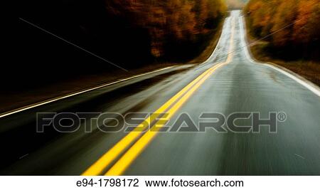 Blurry two lane road in the rain with no traffic in the middle of a forest on Cape Breton, Canada. View Large Photo Image Stock Image - Blurry two lane road in the rain with no traffic in the middle of a forest on Cape Breton, Canada.. Fotosearch