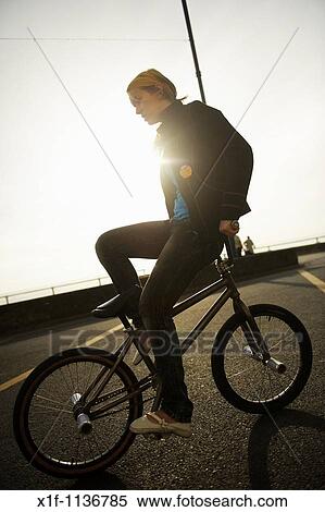 BMX flatland freestyle stunt rider young woman performing stunts on his BMX bike, UK View Large Photo Image Stock Photography - BMX flatland freestyle stunt rider young woman performing stunts on his BMX bike, UK. Fotosearch
