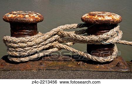 Boat Mooring Line attached to Rusty Bollards on a Quayside. View Large Photo Image Stock Photograph - Boat Mooring Line attached to Rusty Bollards on a Quayside.. Fotosearch