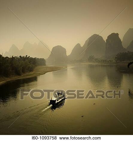 Stock Photo - Boat on the Li River, Yangshuo county, Guilin, Guangxi Province, China. Fotosearch