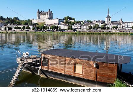 Boat on the River Loire in the town of Saumur, you can see the famous castle, Loire Valley, France View Large Photo Image Stock Photo - Boat on the River Loire in the town of Saumur, you can see the famous castle, Loire Valley, France. Fotosearch