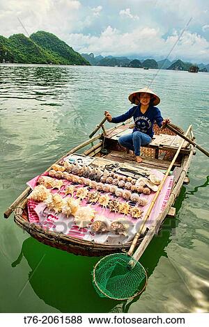 Boat vendor in Halong Bay, Vietnam. View Large Photo Image Stock Photo - Boat vendor in Halong Bay, Vietnam.. Fotosearch