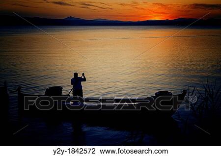 Boatman at sunset in Albufera Lake, Valencia, Spain. View Large Photo Image Stock Image - Boatman at sunset in Albufera Lake, Valencia, Spain.. Fotosearch