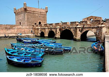 Boats docked in the Skala du port, Essaouira, Morocco View Large Photo Image Stock Photograph - Boats docked in the Skala du port, Essaouira, Morocco. Fotosearch