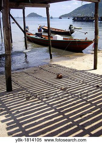 Stock Photography - Boats under the timber pier in Koh Tao, Thailand under the timber pier in Koh Tao, Thailand. Fotosearch