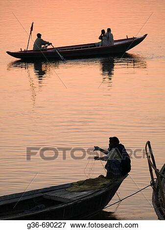 Boats with pilgrims and tourists at dawn in Varanasi, India, a sacred Hindu pilgrimage site. View Large Photo Image Stock Photo - Boats with pilgrims and tourists at dawn in Varanasi, India, a sacred Hindu pilgrimage site.. Fotosearch
