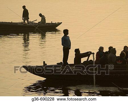 Boats with pilgrims and tourists at dawn in Varanasi, India, a sacred Hindu pilgrimage site. View Large Photo Image Stock Photo - Boats with pilgrims and tourists at dawn in Varanasi, India, a sacred Hindu pilgrimage site.. Fotosearch