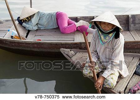 Boatwomen waiting for tourists. Hoi An. Central Vietnam View Large Photo Image Stock Photography - Boatwomen waiting for tourists. Hoi An. Central Vietnam. Fotosearch