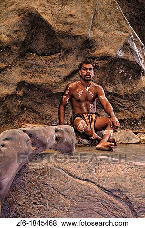 Stock Photo - Body Painted Tjappukai Aboriginal native in Cairns Australia Queensland. Fotosearch