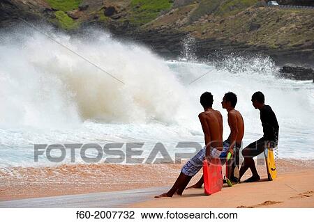 Bodyboarders observe the ocean at Sandy Beach, East Oahu, Hawaii, USA. View Large Photo Image Stock Image - Bodyboarders observe the ocean at Sandy Beach, East Oahu, Hawaii, USA.. Fotosearch