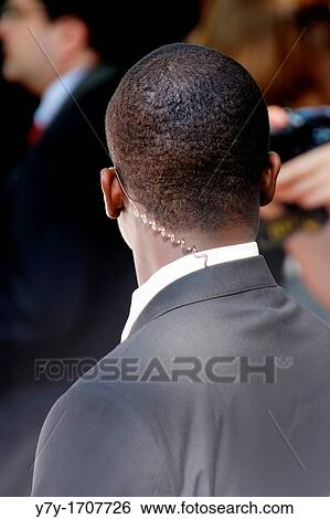 Bodyguard on the lookout, wearing a wire View Large Photo Image Stock Photograph - Bodyguard on the lookout, wearing a wire. Fotosearch