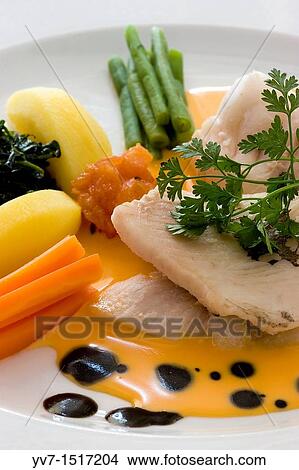 Boiled fish with vegetables and squid sauce View Large Photo Image Picture - Boiled fish with vegetables and squid sauce. Fotosearch