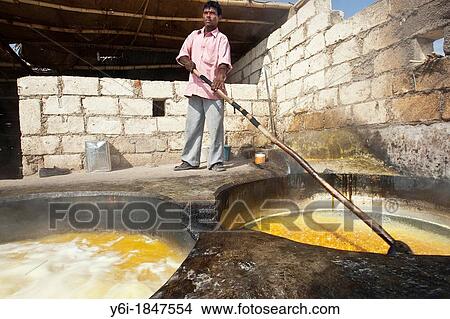 Boiling sugar cane juice to make unrefined sugar jaggery or gur Gujarat India View Large Photo Image Picture - Boiling sugar cane juice to make unrefined sugar jaggery or gur Gujarat India. Fotosearch