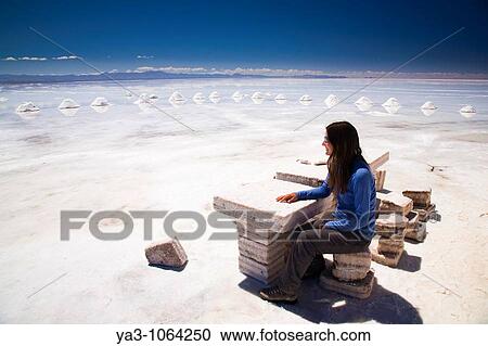 Bolivia, Southern Altiplano, Salar de Uyuni Tourist resting on a seat constructed of salt, located on the Salar de Uyuni salt flat View Large Photo Image Stock Image - Bolivia, Southern Altiplano, Salar de Uyuni Tourist resting on a seat constructed of salt, located on the Salar de Uyuni salt flat. Fotosearch