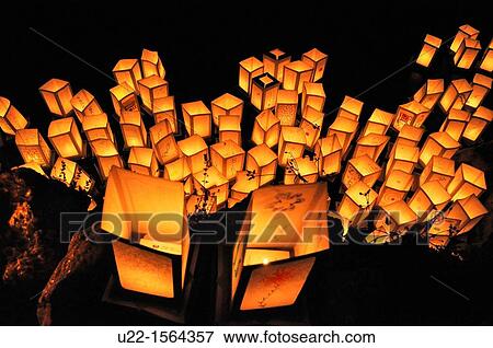 Stock Photo - Bologna (Italy): paper lanterns floating in the Giardini Margherita lake after sunset, to commemorate Hiroshima atomic bomb massacre (August 6th). Fotosearch
