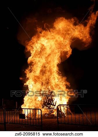 Stock Photography - Bonfire of St. John Night (Nit de Sant Joan) to celebrate Summer Solstice arrival at Sant Carles de la Rapita Village. Montsia Region, Tarragona Province, Catalonia, Spain.. Fotosearch