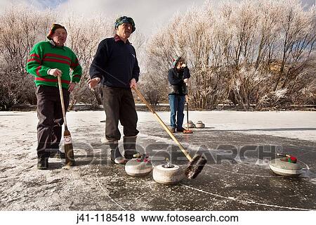 Stock Photo - Bonspiel, national curling competition, July 2010. Idaburn dam, Oturehua, Ida valley, Central Otago, New Zealand. Fotosearch