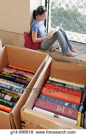 Book sale, boxes, titles, Asian female, browsing, student, reads. Miami-Dade Public Library. Miami. Florida. USA. View Large Photo Image Stock Photo - Book sale, boxes, titles, Asian female, browsing, student, reads. Miami-Dade Public Library. Miami. Florida. USA.. Fotosearch