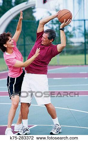 boomer couple playing basketball View Large Photo Image Stock Image - boomer couple playing basketball. Fotosearch